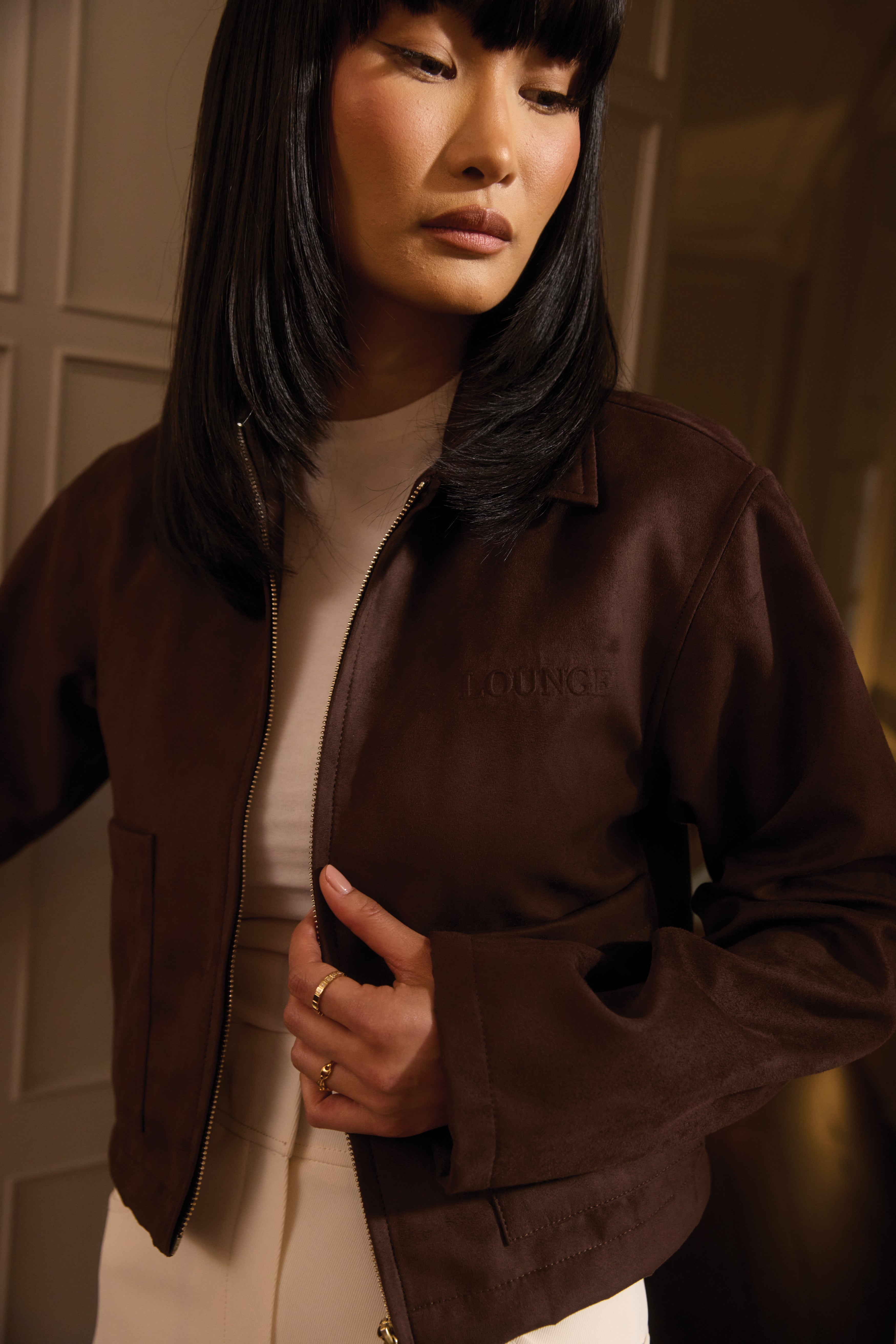 a woman in a brown jacket