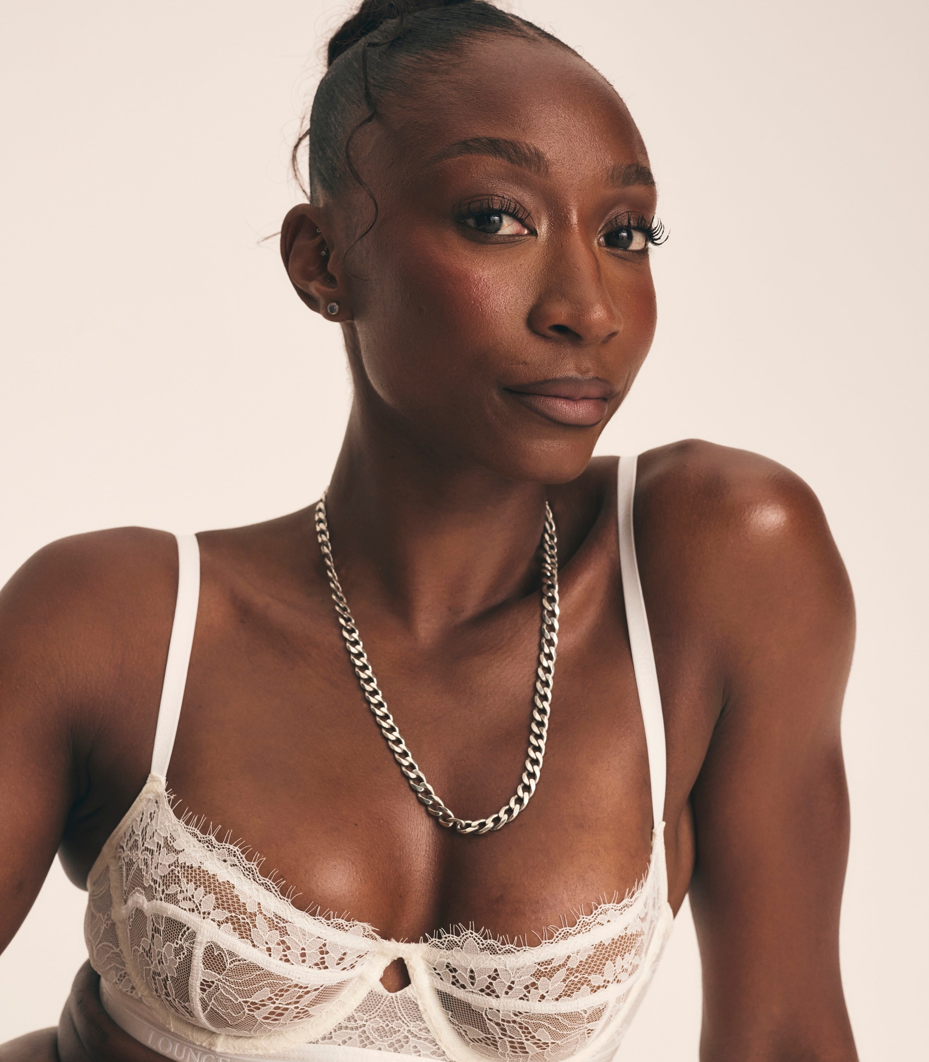 a woman in a white garment and necklace