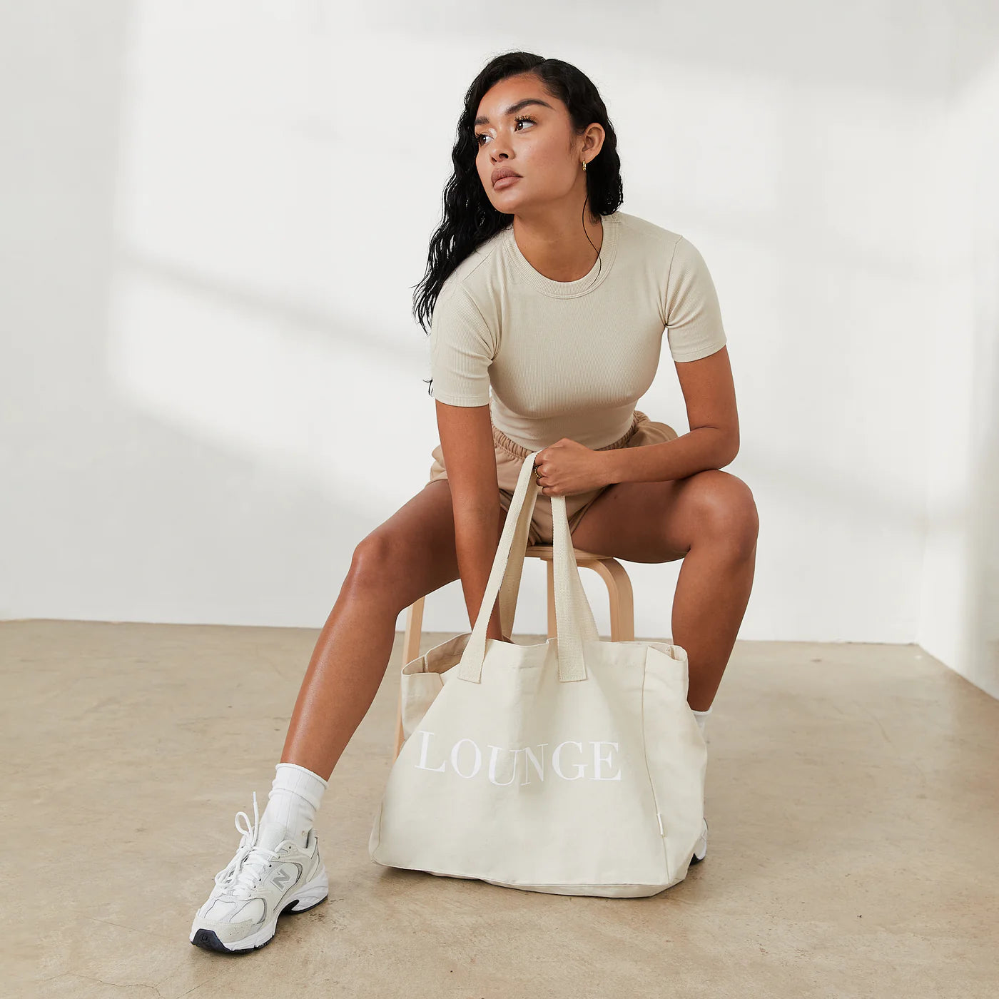 a woman sitting on a chair with a bag