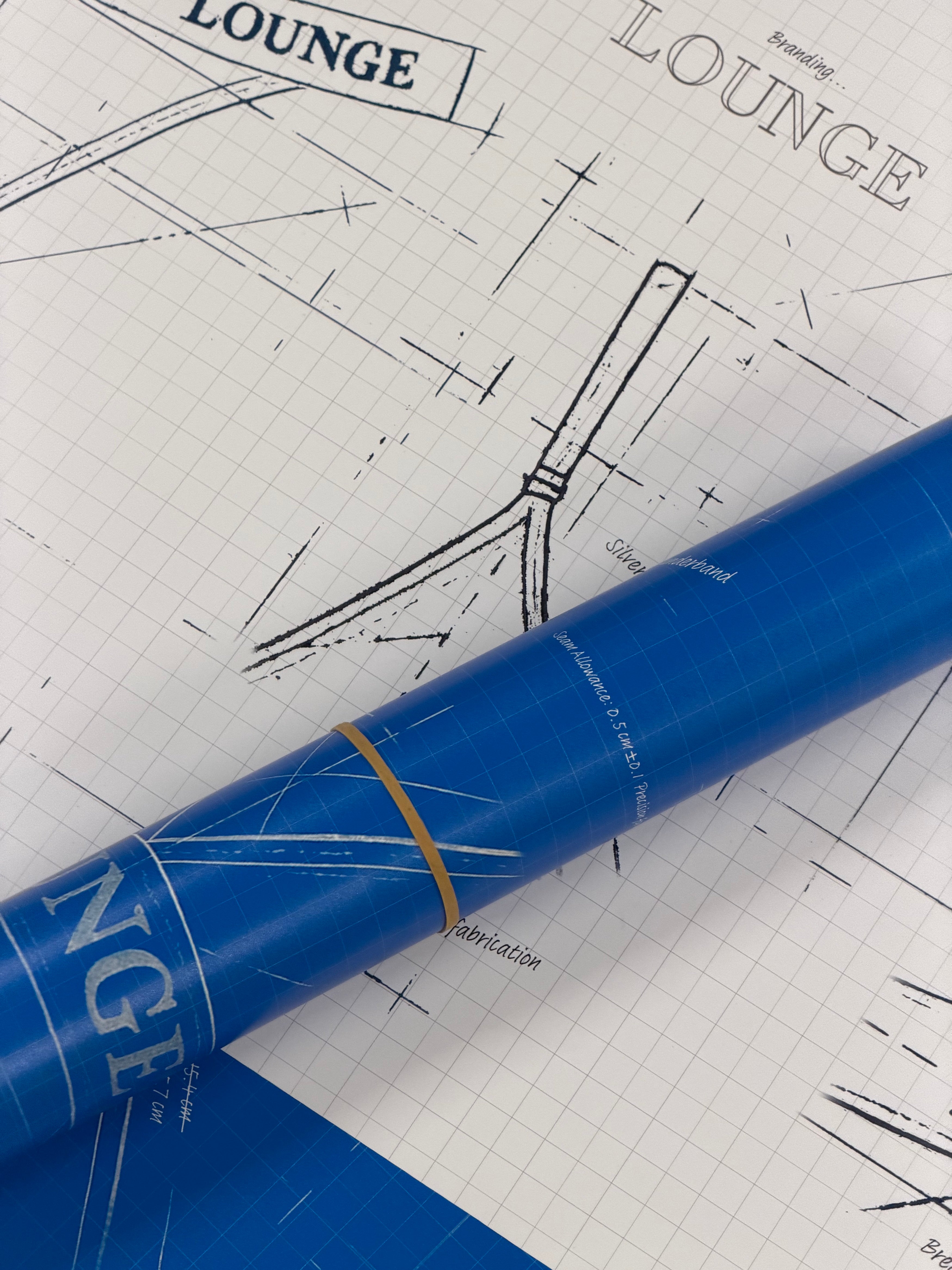 a blue roll of paper on graph paper