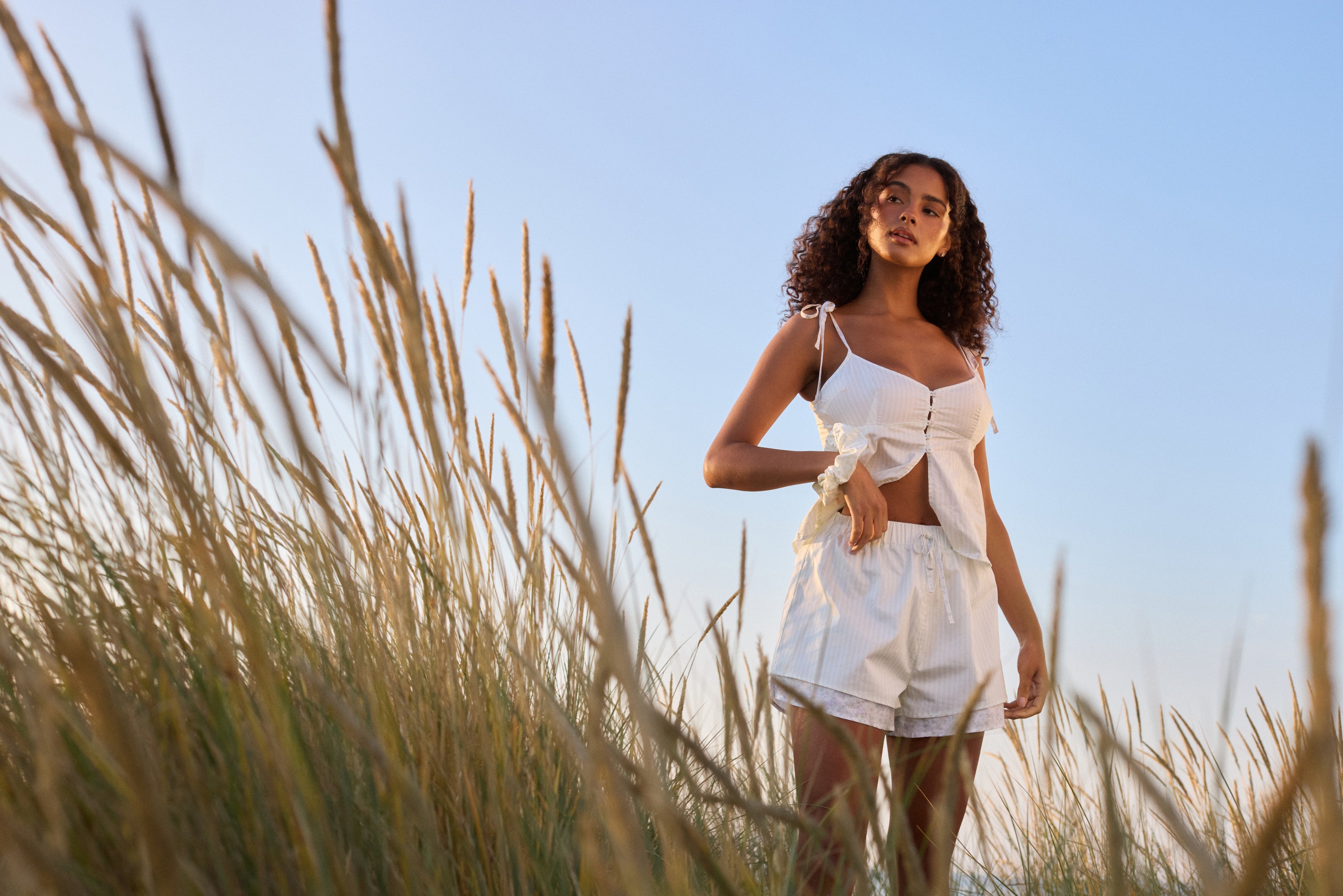 a woman standing in tall grass