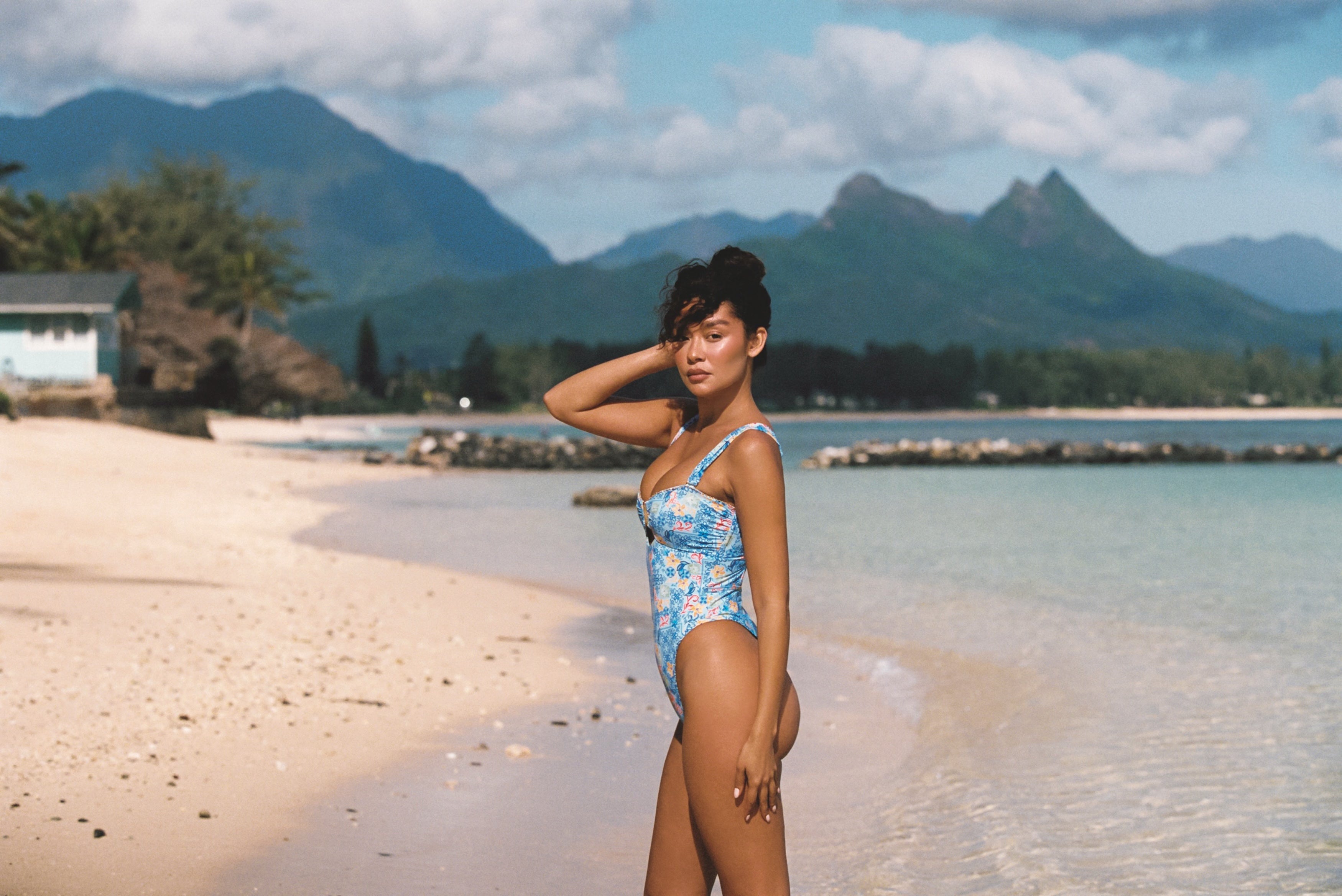a woman in a swimsuit on a beach
