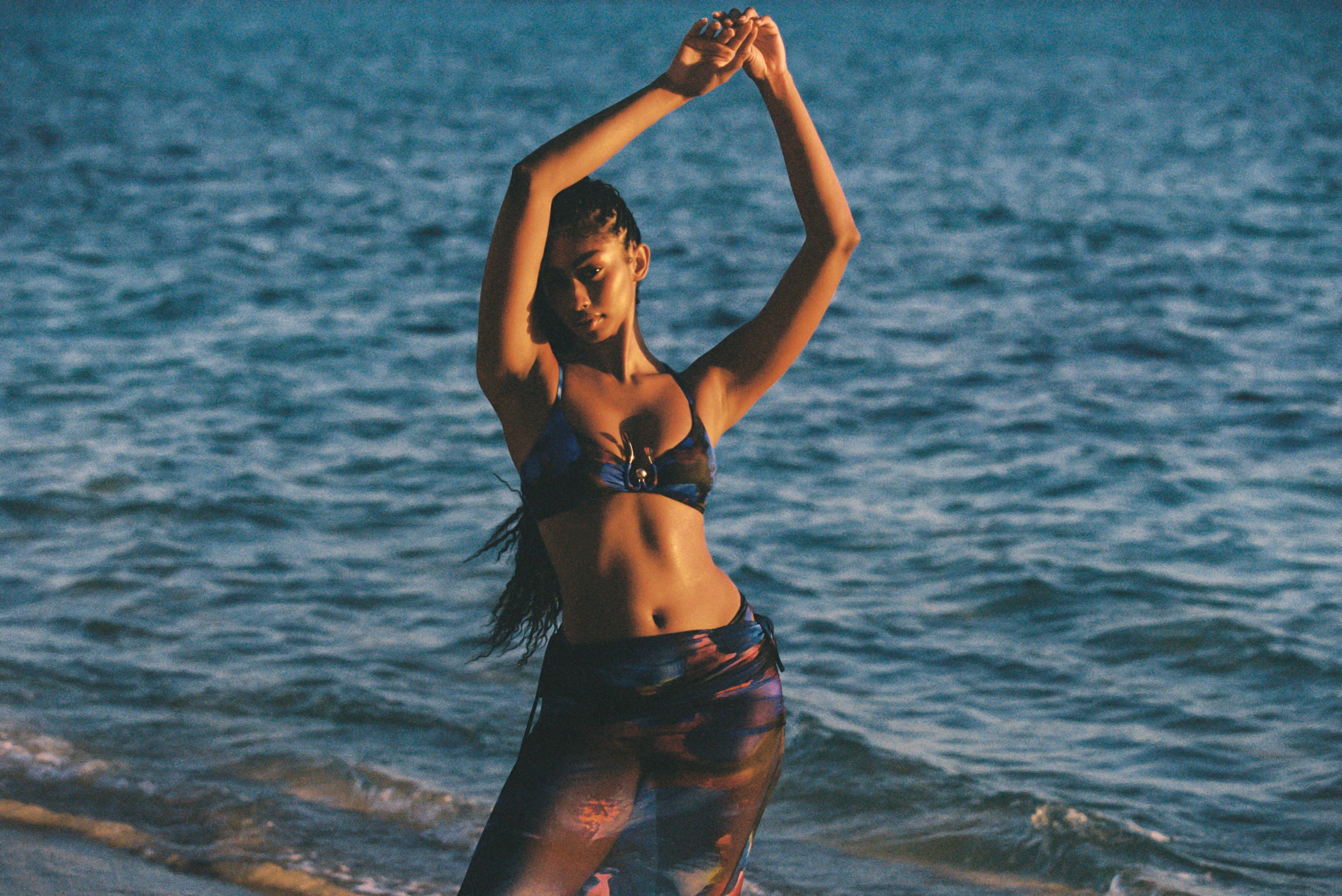 a woman posing for a picture on a beach
